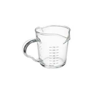 Recipiente medidor de vidrio transparente de 75 ml con asa lateral, marcas de medición y pico vertedor.